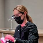 Dental hygienist treating patient