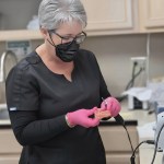Dental assistant preparing equipment