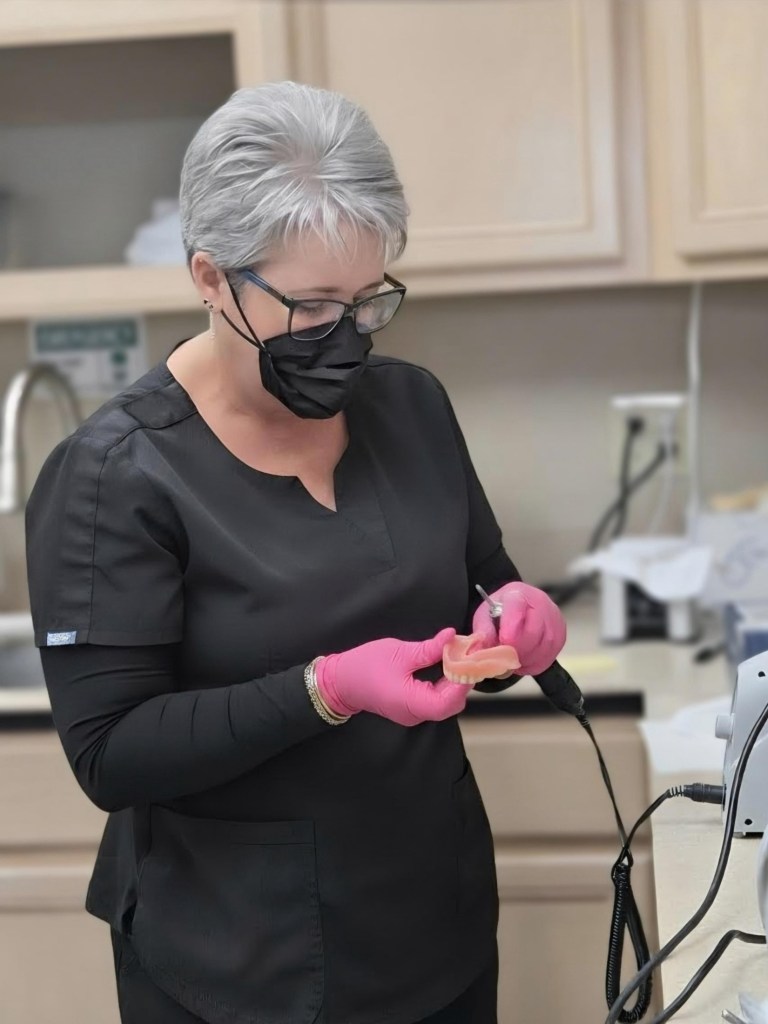 Dental assistant preparing equipment
